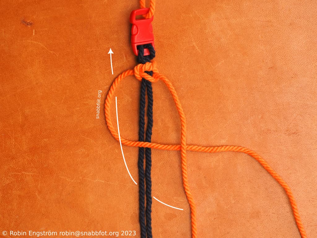 Två snören fästa i ett spänne